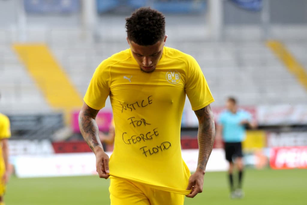Jadon Sancho of Borussia Dortmund celebrates scoring his teams second goal of the game with a 'Justice for George Floyd' shirt during the Bundesliga match between SC Paderborn and Borussia Dortmund at Benteler Arena on May 31, 2020 in Paderborn, Germany.